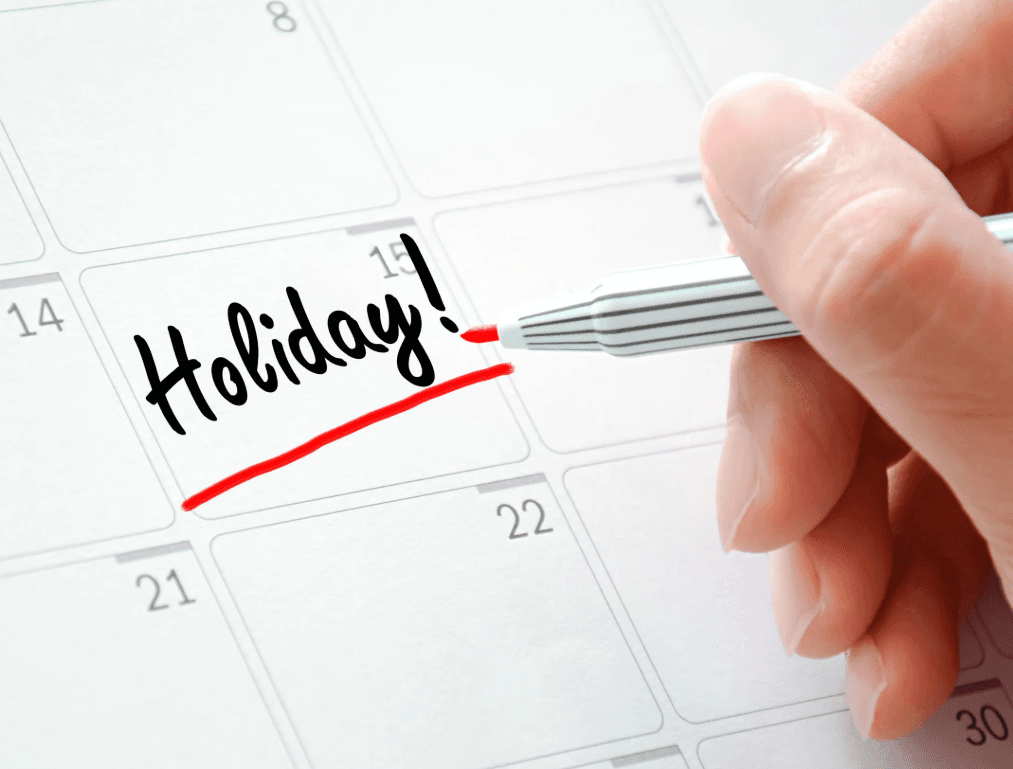 A calendar with the word 'Holiday!' written across it in red marker
